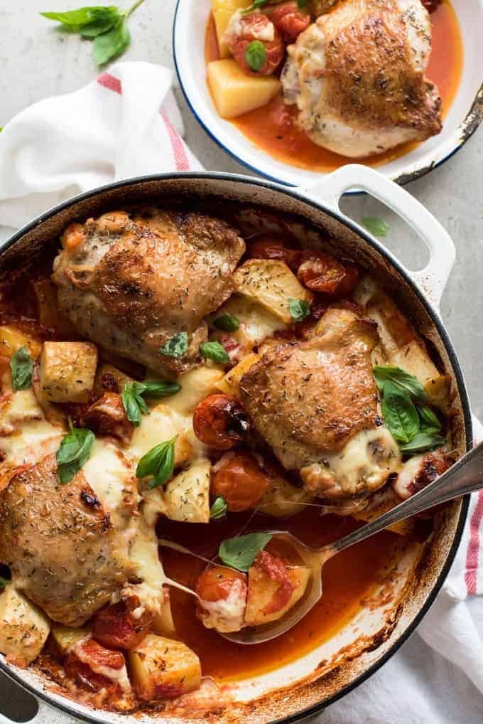 Baked Italian Chicken in a white casserole dish, fresh out of the oven.
