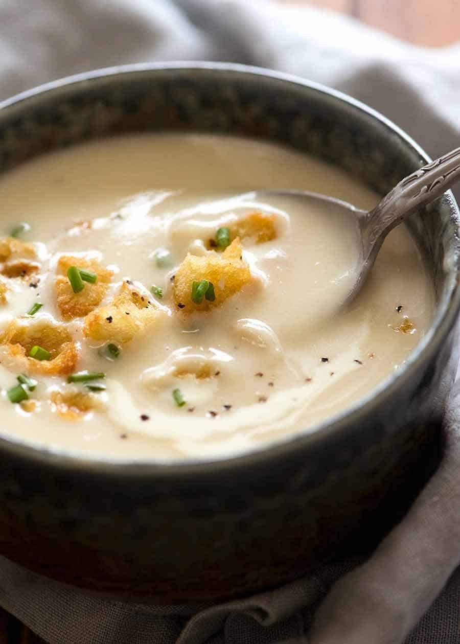 Close up of spoon scooping up thick and creamy Leek and Potato Soup