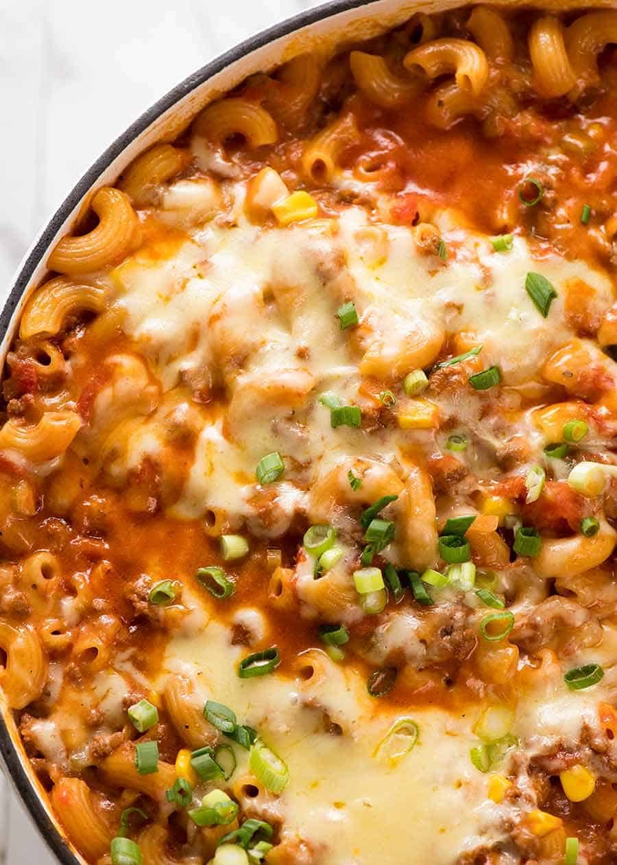 Overhead close up photo of Cheeseburger Casserole - homemade Hamburger Helper - fresh out of the oven in a white cast iron skillet