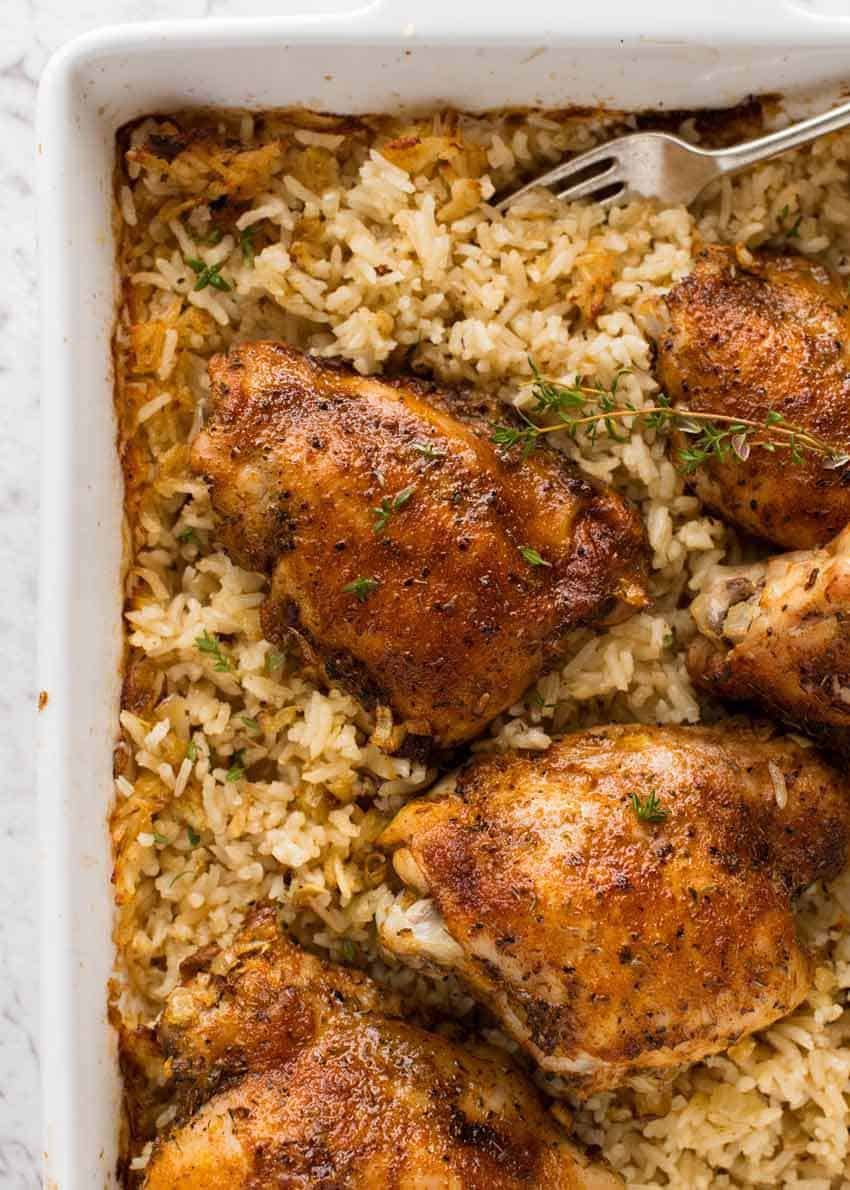 Overhead photo of Baked Chicken and Rice in a white baking dish fresh out of the oven