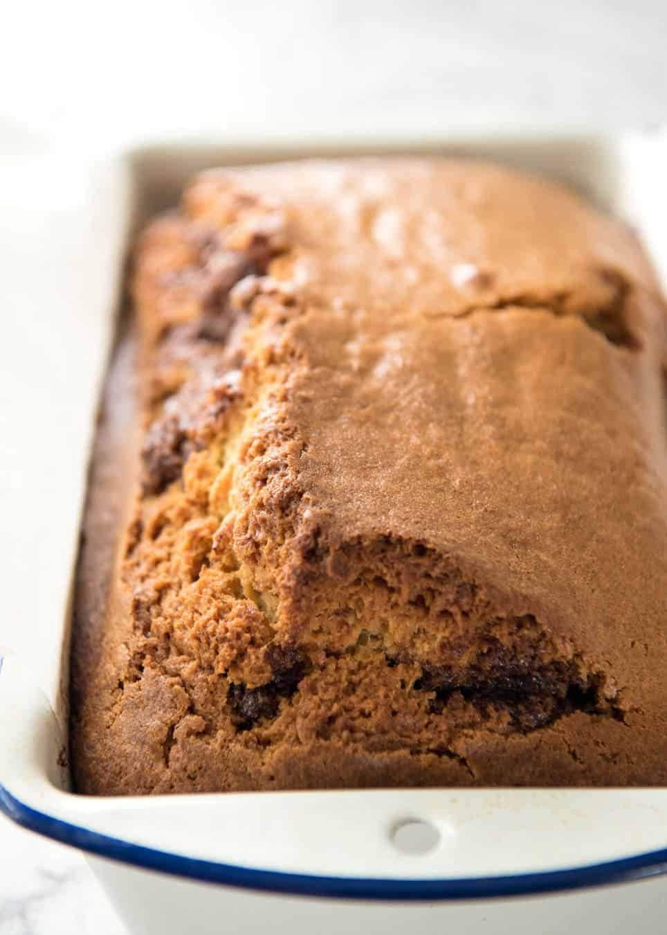Easy Cinnamon Bread in white loaf pan fresh out of the oven