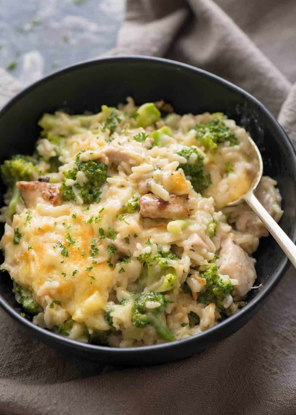 Chicken Broccoli Rice Casserole in a black bowl, ready to be eaten