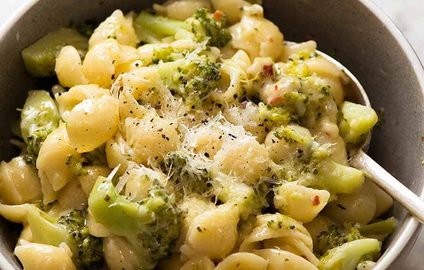 Cheesy broccoli pasta in a rustic blue bowl, ready to be eaten