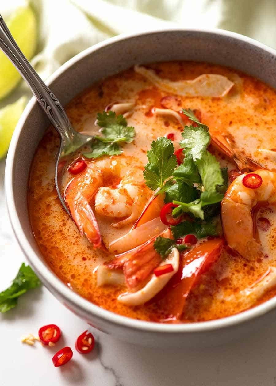 Creamy Tom Yum Soup in a blue bowl, ready to be eaten
