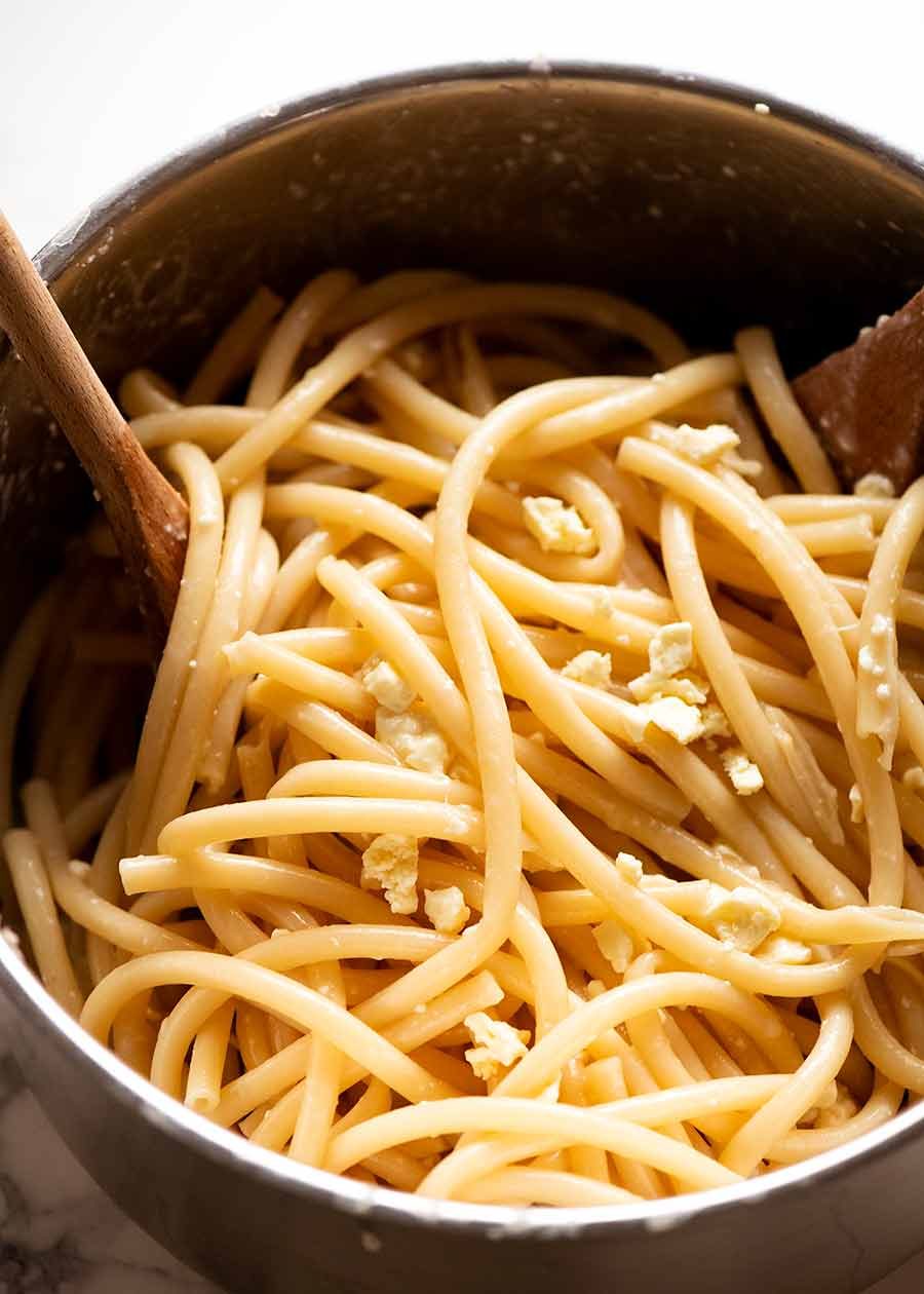 Pot of cooked Bucatini tossed with feta cheese - for Pastitsio