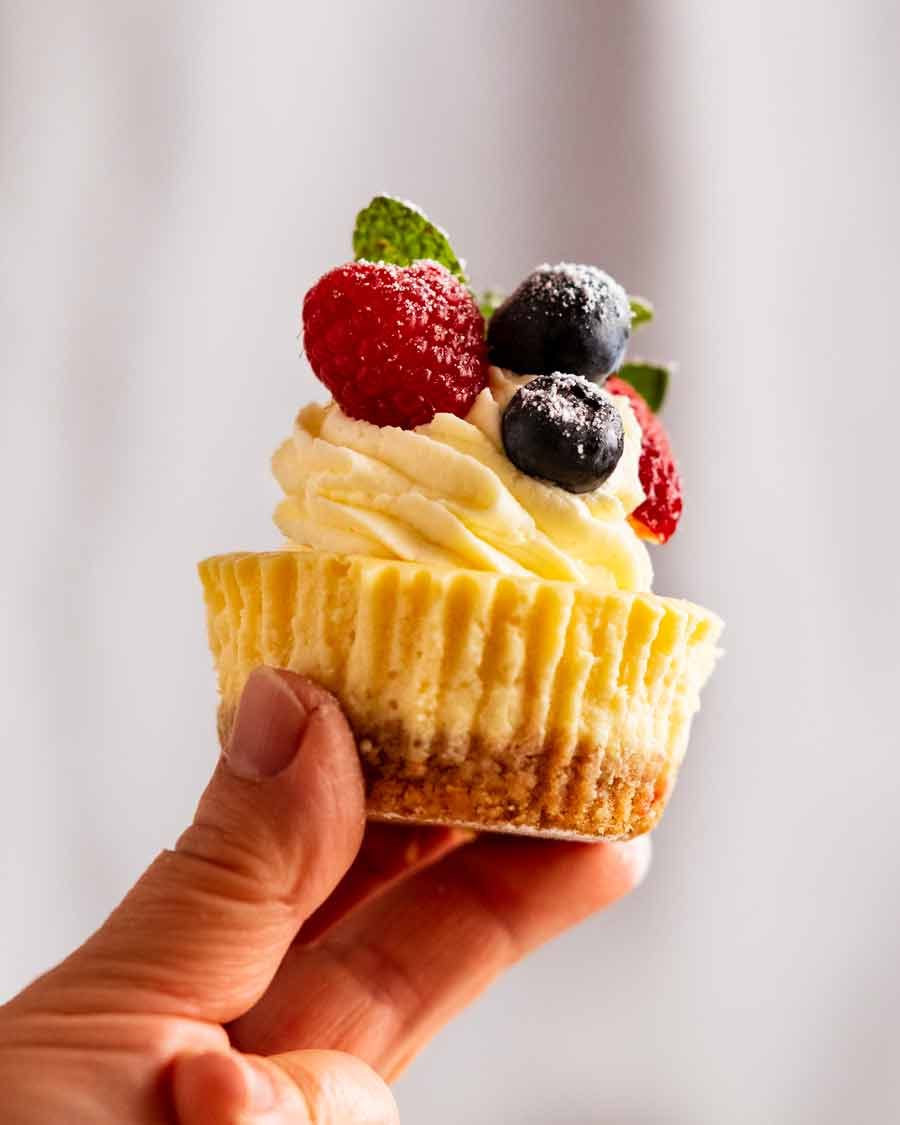 Hand holding Mini cheesecakes